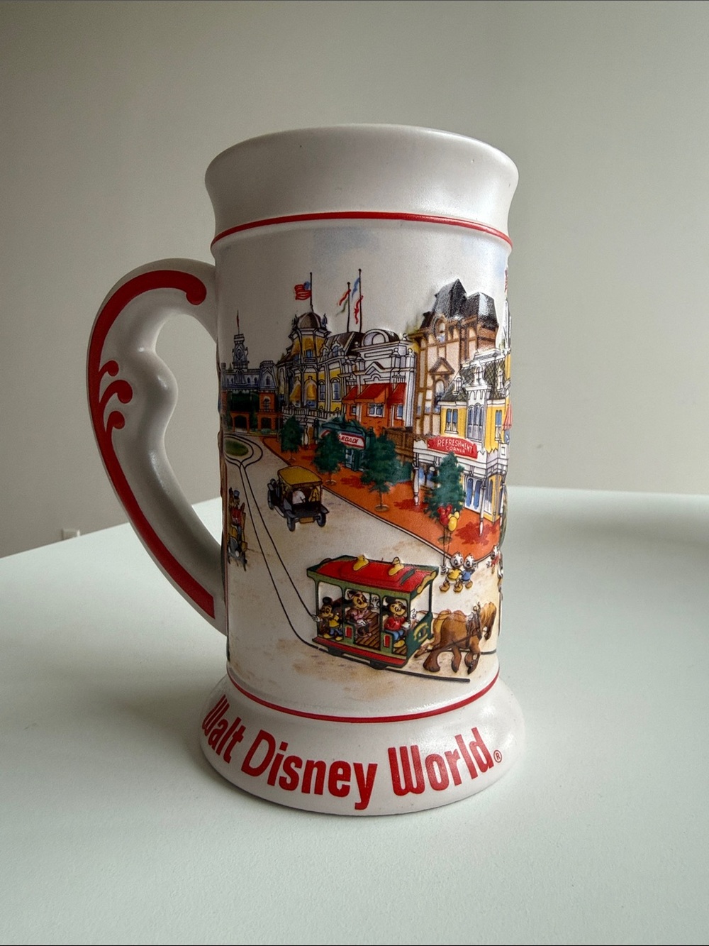 Disney White Ceramic Mug with Red Trim and Multicolor Park Illustration